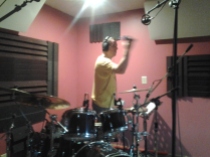 Rascal Flatts' drummer, Jim Riley, overdubs a tamborine part at Nashville Trax Recording Studio